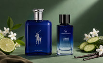 Polo Blue and Camille Rochelle Cobalt Intense cologne bottles displayed on a green surface with bergamot, jasmine, cucumber, vanilla, and suede accents.