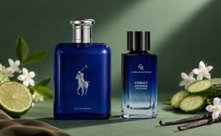 Polo Blue and Camille Rochelle Cobalt Intense cologne bottles displayed on a green surface with bergamot, jasmine, cucumber, vanilla, and suede accents.