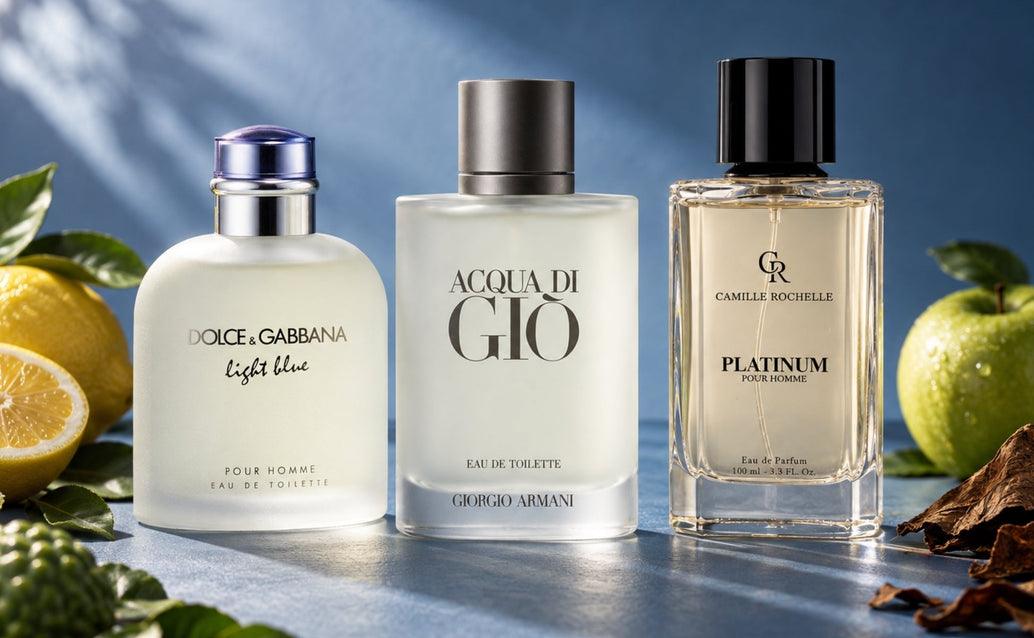 Three men’s fragrance bottles on a matte blue surface, styled with lemon, green apple, tobacco, and leaves under dramatic studio light.