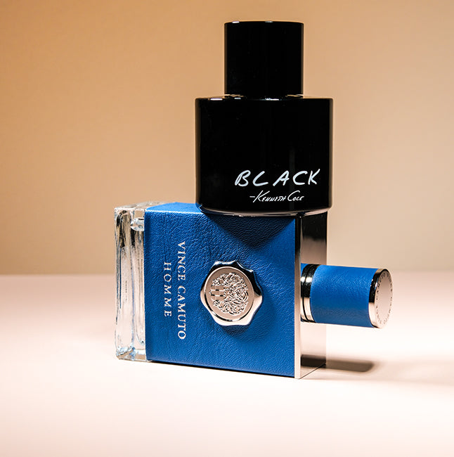 Kenneth Cole Black and Vince Camuto Homme colognes on a warm beige background.