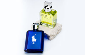 Calvin Klein Eternity for Men and Ralph Lauren Polo Blue cologne bottles displayed on a white background with a stone block.